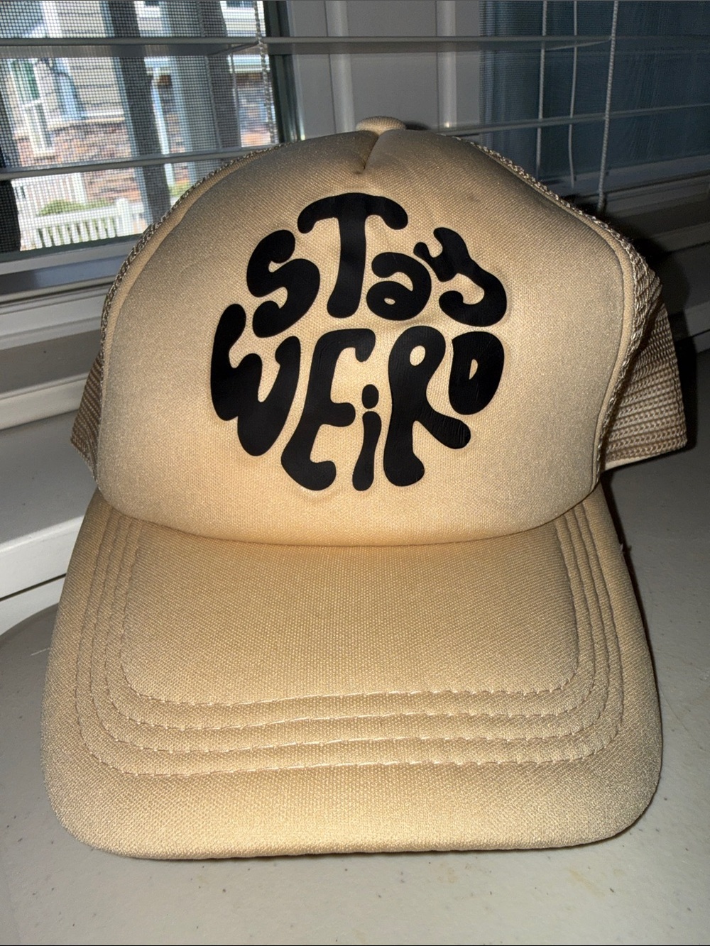 Stay Weird Beige Trucker Hat with Black Graphic